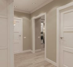 an empty hallway with white doors and wood flooring on both sides, leading to the kitchen