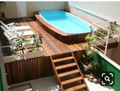 an above ground pool with steps leading up to it and a wooden deck next to the pool