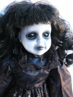 a close up of a doll with black hair