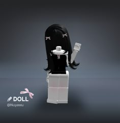 the doll is wearing a black dress and holding a white cup with pink bows on her head