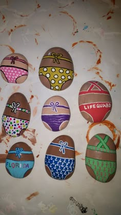 six painted eggs with different designs on them