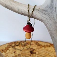 a red and yellow mushroom on a chain