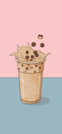 a cup filled with chocolate chip cookies on top of a blue table next to a pink wall