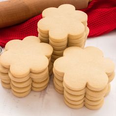 several cookies are stacked on top of each other with a rolling pin in the background