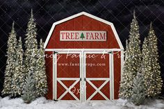 a red barn with christmas trees and lights