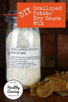 a jar filled with potato sauce next to a pile of tortilla chips on top of a wooden table