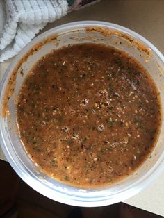 a bowl filled with soup sitting on top of a table