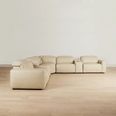 a white couch sitting on top of a hard wood floor