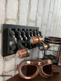 a pair of goggles sitting on top of a table next to a wall mounted wine rack