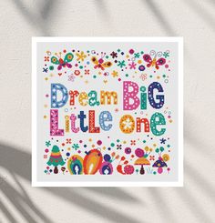 a cross - stitch pattern with the words dream big little one in bright colors on a white background