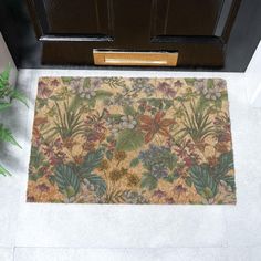 a door mat with flowers and leaves on it