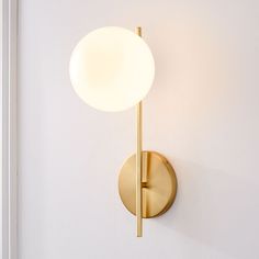 a light that is on the wall next to a white wall with a door handle