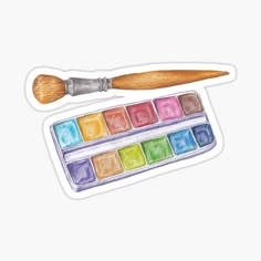 a watercolor palette with a wooden brush sticker