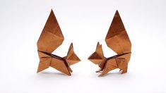 two brown origami birds sitting next to each other