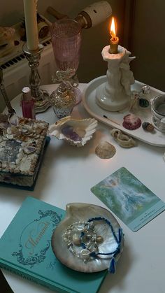 the table is covered with seashells, candles and other decorative items on it