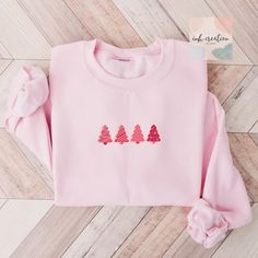 Christmas Tree Cake Sweatshirt, Pink Tree Christmas Sweater, Christmas Crewneck, Cute Holiday Sweatshirt, Pink Christmas Tree Cookie Sweater ❤ Gildan Brand Sweatshirts & Unisex Adult Sizing Our Unisex Heavy Blend Crewneck Sweatshirt is all about cozy comfort and effortless style. Made from a lovely blend of polyester and cotton, it keeps your favorite designs looking fresh and beautiful. The absence of itchy side seams means you'll stay cozy and irritation-free. Perfect for layering or wearing on its own, this sweatshirt is your go-to for a relaxed, feminine touch. ❤ Please note that the rolled sleeves in our photos are for styling inspiration only, and any props shown are not included with your purchase. ❤ PRINT Our sweatshirts are printed using Direct-To-Garment technology, ensuring dura Cookie Sweater, Pink Tree Christmas, Top Girlfriend, Christmas Tree Cake Shirt, Merry And Bright Christmas Tree, Christmas Sweatshirt Ideas, Cute Crewneck Sweatshirt, Holiday Party Tops, Bright Christmas Tree