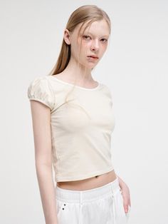 This is a trendy and feminine top by ETMON that is made out of high quality and sturdy material. With distinctive mood of the design and modern feminine look, you can style it for your casual daily outfit.- Wide round neckline and slim silhouette- Strap with hole slits on the back- Feminine and trendy look Fitted Cream T-shirt With Crew Neck, Chic Fitted Crop Top T-shirt, Fitted Cotton Puff Sleeve Top With Crew Neck, Modern Stretch T-shirt For Summer, Trendy Spring Short Sleeve Crew Neck Top, Trendy Relaxed Fit Puff Sleeve Top, Chic Short Sleeve Crew Neck Top For Day Out, Trendy Summer Crew Neck Blouse, Chic Crew Neck Short Sleeve Top For Day Out