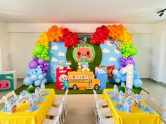 a birthday party set up with balloons, decorations and tableware for children's birthday