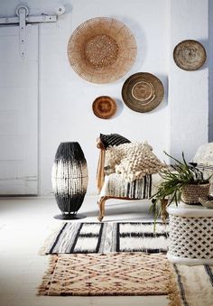 a living room filled with lots of different types of decor on the wall and floor