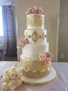 a three tiered wedding cake sitting on top of a table