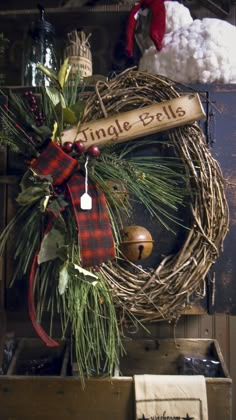 a wreath with a sign that says uncle bells hanging from it's front door