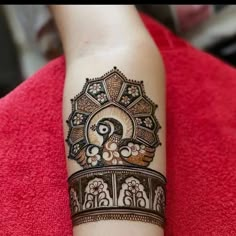 a woman's arm with a henna tattoo on it