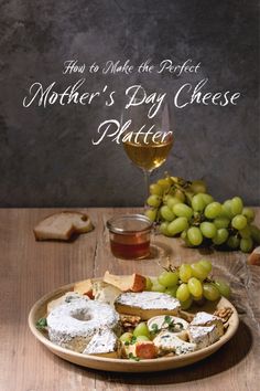 a plate full of cheese, grapes and bread on a wooden table with the words how to make the perfect mother's day cheese platter