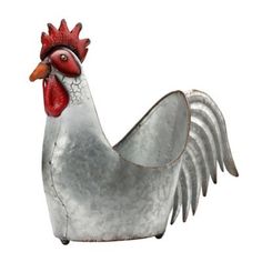 a metal rooster statue sitting on top of a white floor