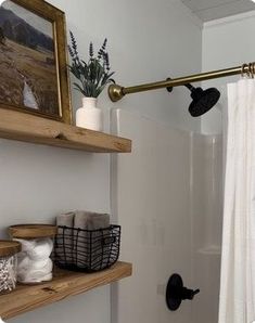 a bathroom with white walls and wooden shelves