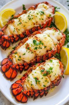 lobsters with lemon and parsley on a white plate