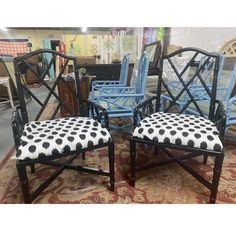 three chairs with black and white cushions on top of a rug in a room filled with furniture