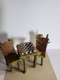 two chairs sitting next to each other near a table with chess pieces on top of it