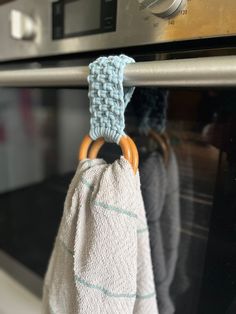 a towel hanging on the handle of an oven door with a ring in front of it