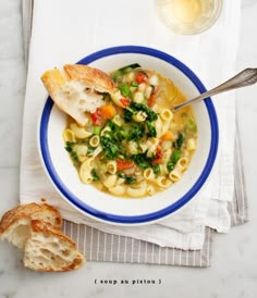 a bowl of soup with pasta and vegetables