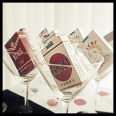 three wine glasses filled with candy sitting on top of a table next to each other