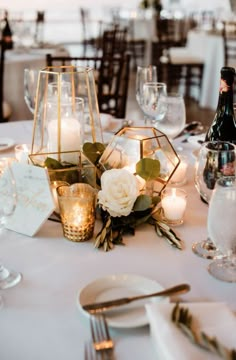 the table is set with candles and flowers