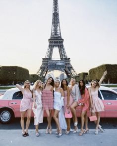 the girls are posing in front of the eiffel tower