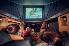 people watching cartoons on television in the back of a vehicle