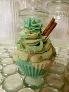 there is a cupcake with green frosting and cinnamon sticks in the top half