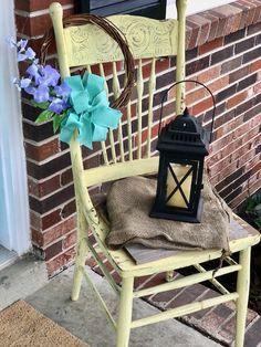 a yellow chair with a blue flower and a lantern on it