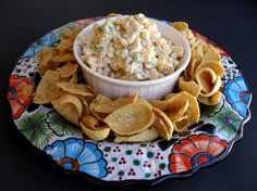 a plate with chips and a bowl of dip