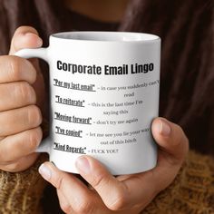 a person holding a coffee mug with the words corporate email lingo printed on it