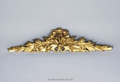 an ornate gold leafy design on a white background