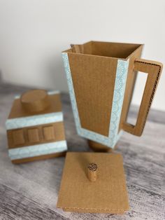 a coffee cup and coaster made out of cardboard