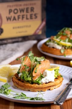 a plate topped with food next to a box of power waffles on top of a wooden table