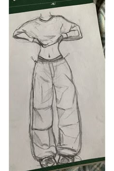 a drawing of a woman's shirt and pants on a piece of white paper