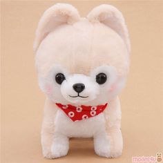 a small white stuffed animal with a red bow around it's neck and eyes