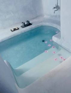 a bath tub with flowers floating in it