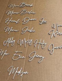 the names of many people are written in white ink on a brown cardboard box with black writing