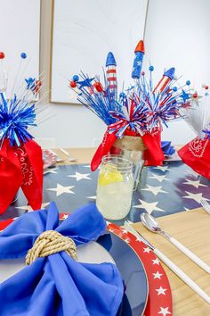 a patriotic table setting with red, white and blue decorations